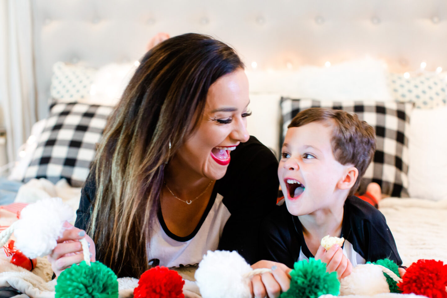 Heather and her son Leyton smile at each other while making Christmas decorations