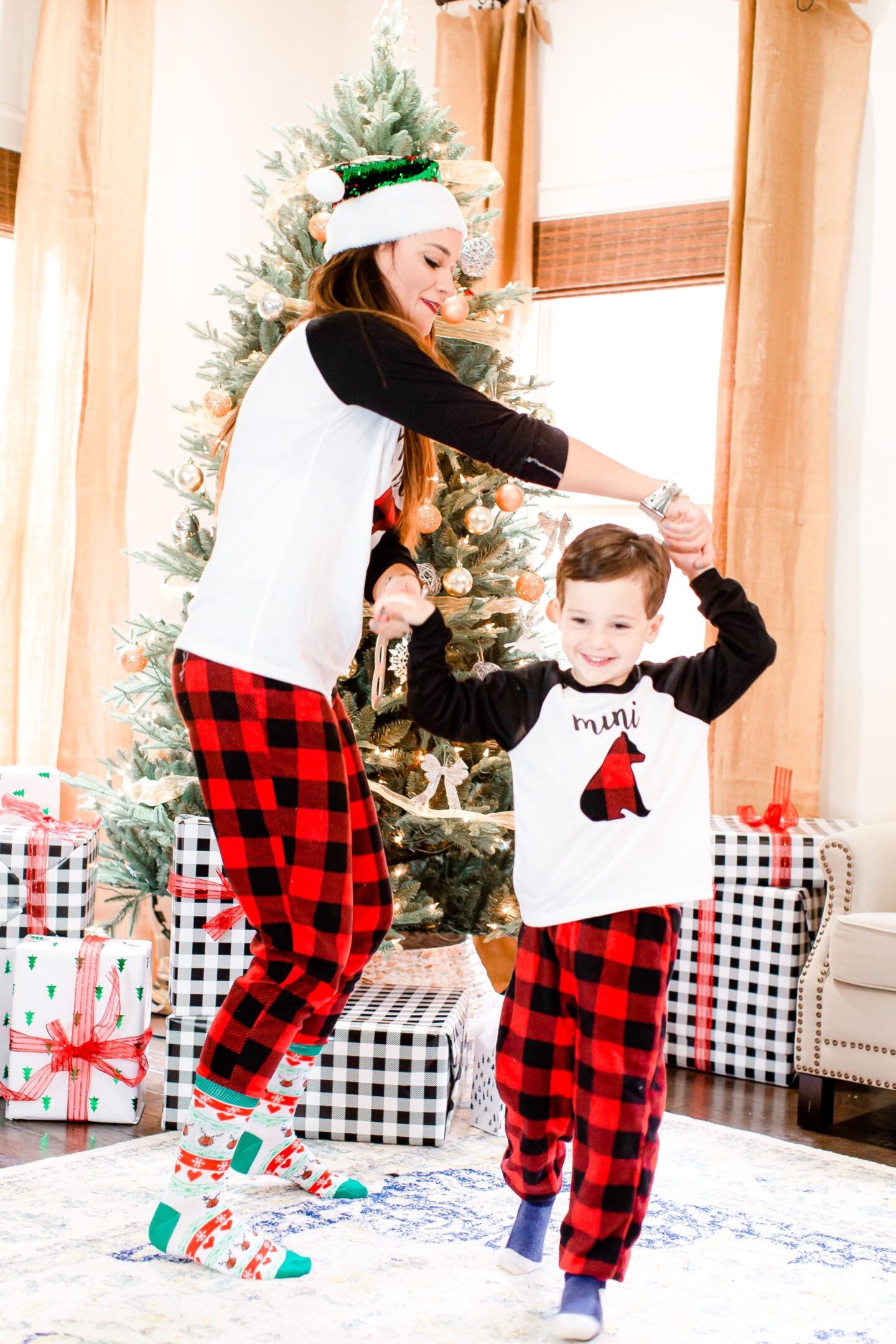 Heather dances with her son in Christmas pajamas 