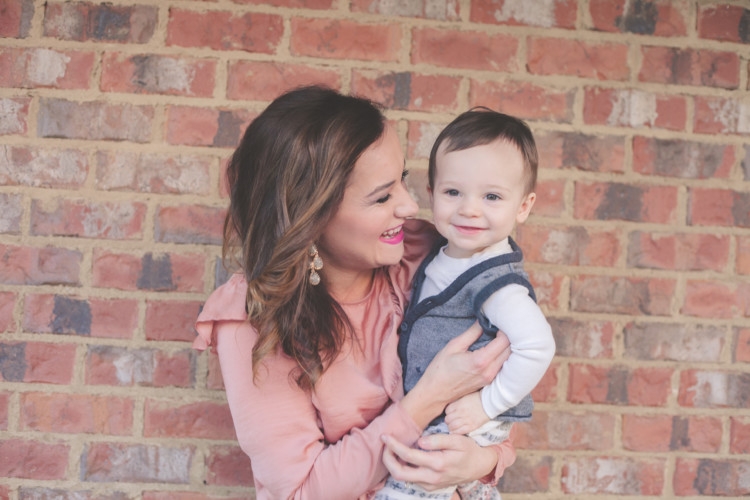 Mom and Baby pink style // Valentine's Day Mom & Baby Outfit // Valentine's Day Mom Outfit from Heather of MyLifeWellLoved.com Baby Boy and Mom Fashion | Cute Valentine's Day Outfits for Mom & Baby featured by top life and style blog, My Life Well Loved: image of a woman wearing a TOPSHOP ruffle tee, TOPSHOP skinny jeans, Rag & bone leather booties. Baby wears a Tea boy tee shirt, H&M vest and Freshly Picked moccs.