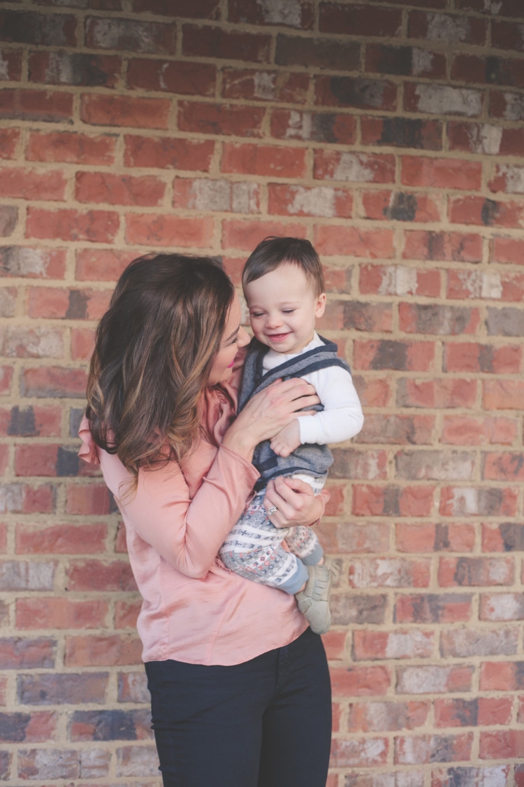 Mom and Baby pink style // Valentine's Day Mom & Baby Outfit // Valentine's Day Mom Outfit from Heather of MyLifeWellLoved.com Baby Boy and Mom Fashion | Cute Valentine's Day Outfits for Mom & Baby featured by top life and style blog, My Life Well Loved: image of a woman wearing a TOPSHOP ruffle tee, TOPSHOP skinny jeans, Rag & bone leather booties. Baby wears a Tea boy tee shirt, H&M vest and Freshly Picked moccs.