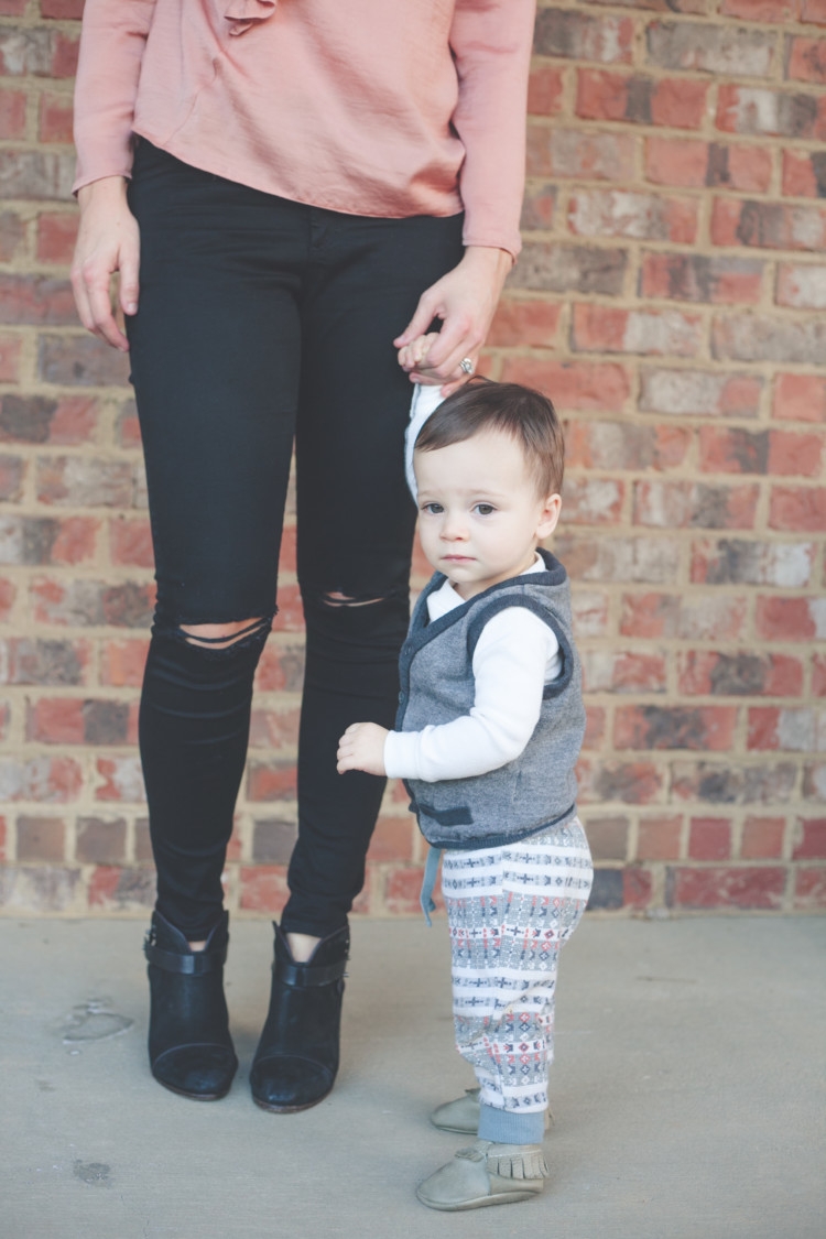 Mom and Baby pink style // Valentine's Day Mom & Baby Outfit // Valentine's Day Mom Outfit from Heather of MyLifeWellLoved.com Baby Boy and Mom Fashion | Cute Valentine's Day Outfits for Mom & Baby featured by top life and style blog, My Life Well Loved: image of a woman wearing a TOPSHOP ruffle tee, TOPSHOP skinny jeans, Rag & bone leather booties. Baby wears a Tea boy tee shirt, H&M vest and Freshly Picked moccs.